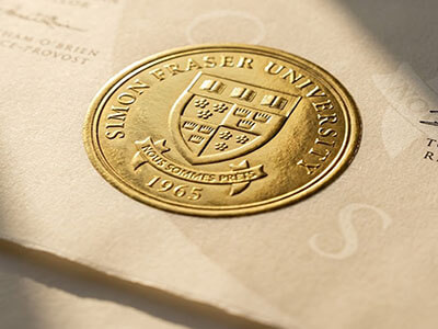 Detailed close-up of a high quality fake degree with authentic gold foil embossed seal.